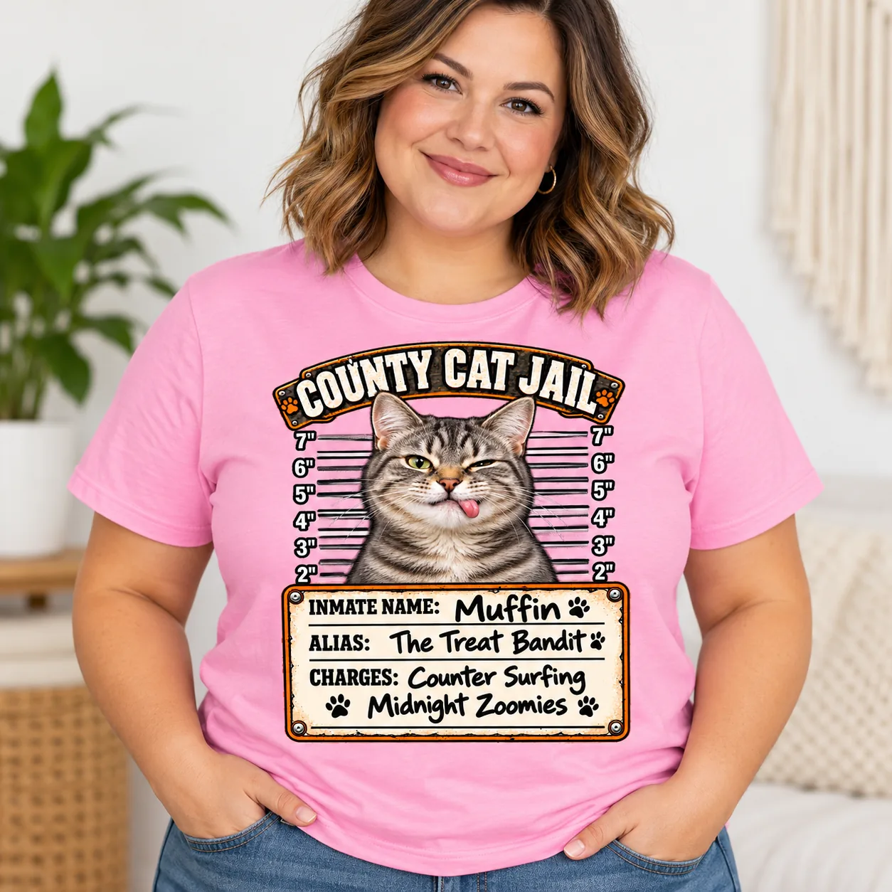 Pink shirt showing a sample personalized cat mugshot design.
